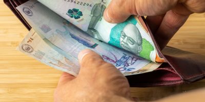 Hand taking money out of wallet, Colombia Peso banknotes, Concept, rising prices, value of Colombian currency