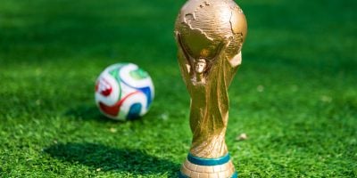 May 7, 2026, United States. The trophy of the 2026 FIFA World Cup and the official Adidas Trionda ball on the green lawn of the stadium.